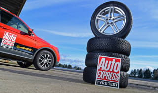 Stack of tyres next to a Volkswagen Tiguan