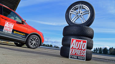 Stack of tyres next to a Volkswagen Tiguan
