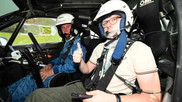 Auto Express consumer reporter Tom Jervis sitting in a Skoda Fabia rally car