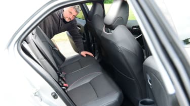 Auto Express current affairs and features editor Chris Rosamond inspecting the Toyota Corolla&#039;s back seats