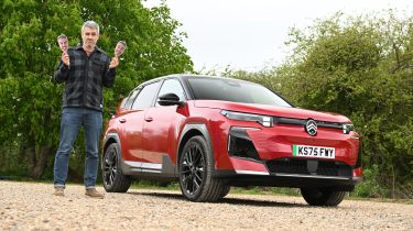 Auto Express deputy editor Richard Ingram standing next to the Citroen e-C5 Aircross