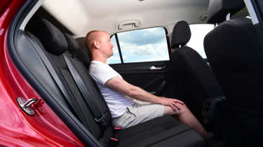 Volkswagen T-Roc - rear seats being sat in by Auto Express chief reviewer Alex Ingram 