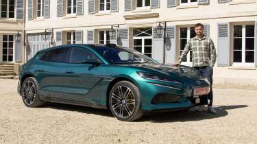 Auto Express senior news reporter Alastair Crooks standing next to the Denza Z9GT EV