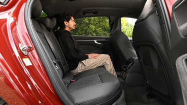 Auto Express senior staff writer Jordan Katsianis sitting in the Audi A6 e-Hybrid&#039;s back seat