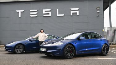 Auto Express senior staff writer Jordan Katsianis standing between two Tesla Model 3s