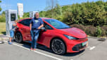 Auto express deputy editor John McIlroy standing with the Cupra Born while it charges