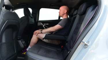 Auto Express chief reviewer Alex Ingram sitting in the BMW iX2&#039;s back seat