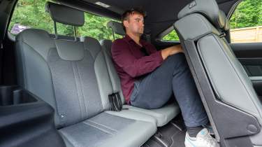 Alastair Crooks sitting in the back seats of the Kia Sorento