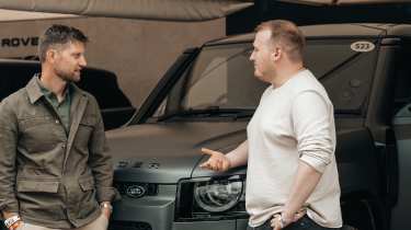 Auto Express news reporter Ellis Hyde standing with Shaun Birch in front of the Land Rover Defender Octa