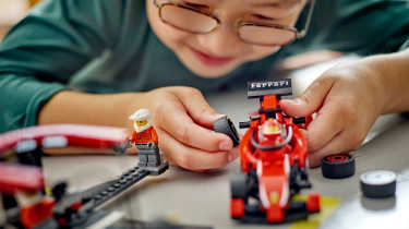 Child playing with a Lego set