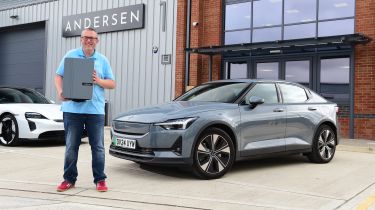 John McIlroy standing next to the Polestar 2 outside the Andersen factory 