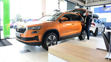 Auto Express staff photographer Pete Gibson fitting a roof rack to the Skoda Karoq