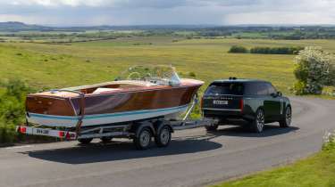 Range Rover Electric towing a boat