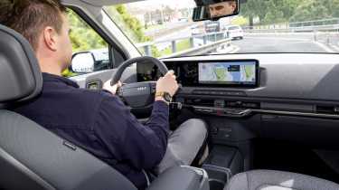 Alastair Crooks driving in the Kia EV2