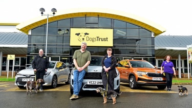 Auto Express consumer and current affairs editor Chris Rosamond standing with a number of Skodas, dogs and Dogs Trust staff