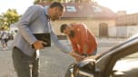 Two people inspecting a used car