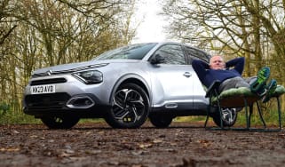 Auto Express executive editor Paul Adam sitting in a camping chair next to the Citroen C4 X