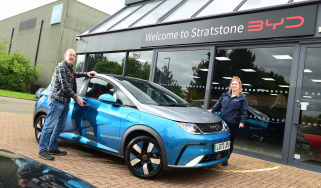 Auto Express chief sub-editor Andy Pringle and BYD representative Sophie Barella standing outside a BYD showroom