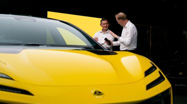 Auto Express editor-at-large Phil McNamara standing next to a Lotus Emeyal