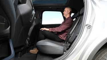 New BMW iX3 40 M Sport - rear seats being sat in by Auto Express deputy editor Richard Ingram