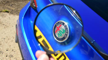 Alfa Romeo Giulia Quadrifoglio - alfa romeo badge (through magnifying glass)
