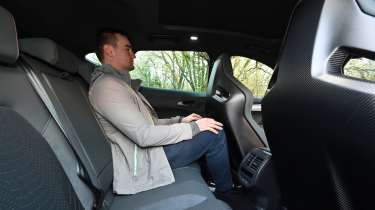 Auto Express senior news reporter Alastair Crooks sitting in the Cupra Formentor e-Hybrid&#039;s rear seat