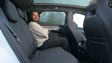 Auto Express news editor Jordan Katsianis sitting in the BYD Sealion 7's back seat