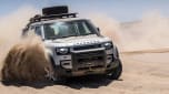 Land Rover Defender driving through sand