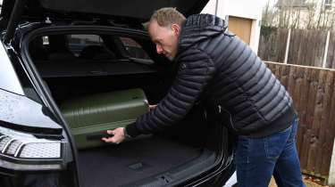 Volkswagen ID.7 Tourer - boot with Auto Express’ editor-at-large, Phil McNamara loading a suitcase
