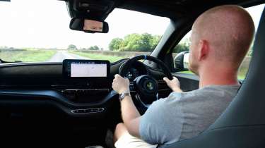 Abarth 500e - interior driving shot wi special contributor Alex Ingram