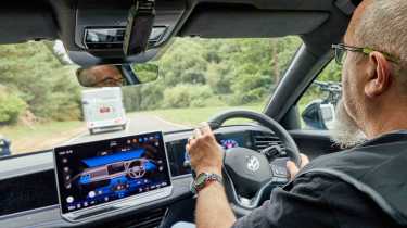 Volkswagen Passat R-Line - interior driving shot while towing with senior test editor Dean Gibson