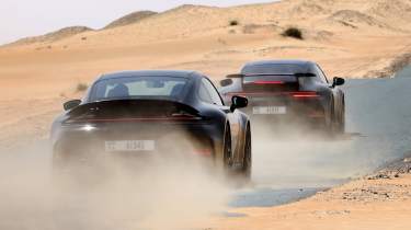 New Porsche 911&#039;s rear 3/4 driving down a desert road