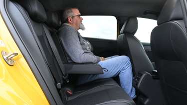New Volkswagen T-Roc 2026 - rear interior, car being sat in by Auto Express senior test editor Dean Gibson 