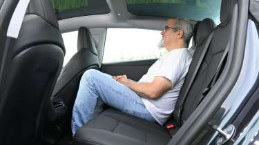 Auto Express senior test editor Dean Gibson sitting in the Tesla Model 3's rear seat