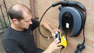 Pod Point technician testing a Pod Point SOLO S3 wallbox charger