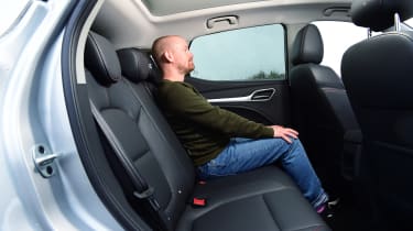 Auto Express chief reviewer Alex Ingram sitting in the back seat of the MG ZS