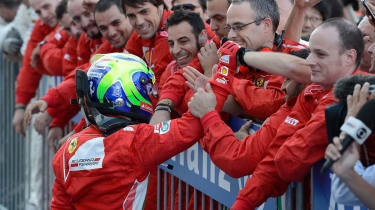 Felipe Massa celebrates at the pit wall