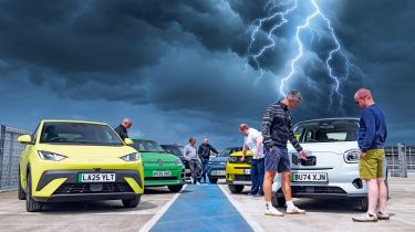 Auto Express team standing with a selection of EVs underneath a lightning storm