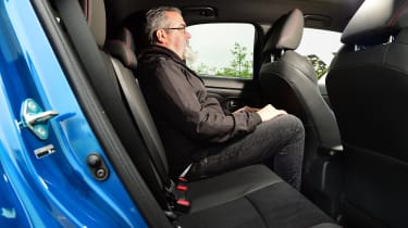 Auto Express senior test editor Dean Gibson sitting in back seat of Toyota Yaris Cross