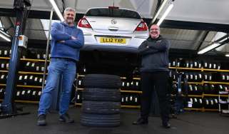 Auto Express consumer editor Chris Rosamond and Protyre area manager Simon Hall standing next to a vehicle inspection ramp
