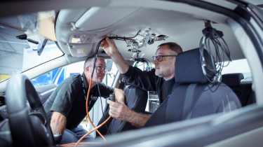 Horiba Mira technician&#039;s connecting crash testing equipment to a car