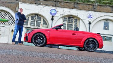 Auto Express contributing editor Steve Sutcliffe standing next to the Audi TT Roadster Final Edition outside Brighton and Hove Albion football club