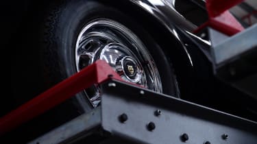 Jaguar wheel strapped onto workshop ramp