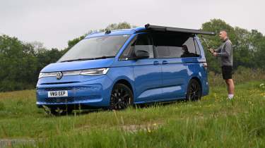 Auto Express deputy editor Richard Ingram unfolding the Volkswagen California eHybrid's awning