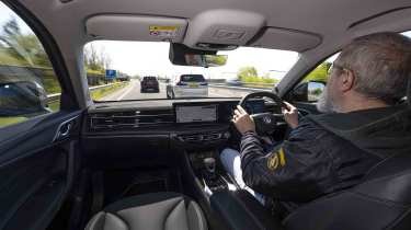 MG HS PHEV - interior driving shot with Senior test editor, Dean Gibson