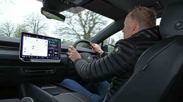 Volkswagen ID.7 Tourer - interior driving shot with Auto Express’ editor-at-large, Phil McNamara behind the wheel