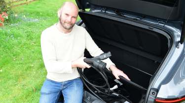 Auto Express creative director Darren Wilson removing charging cables from the Hyundai Kona Electric&#039;s boot