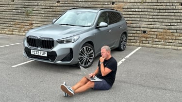 Auto Express special contributor Steve Sutcliffe browsing on a laptop while sitting next to the BMW X1