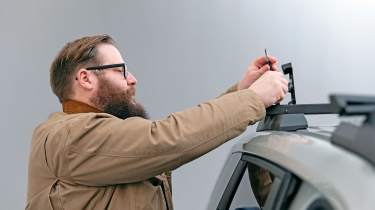 Dacia owner inspecting the Dacia Duster&#039;s roof rack