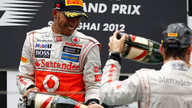 Lewis and Jenson celebrate on the podium
